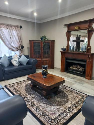 a living room with a couch and a coffee table at J'Cups Guest House in Centurion