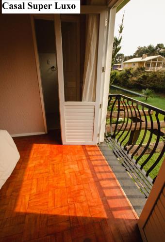 an open door of a house with a balcony at Pousada São Chico Eco Village in São Francisco de Paula