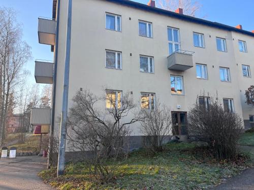 a white building with windows on the side of it at Cozy Condo in Käpylä in Helsinki