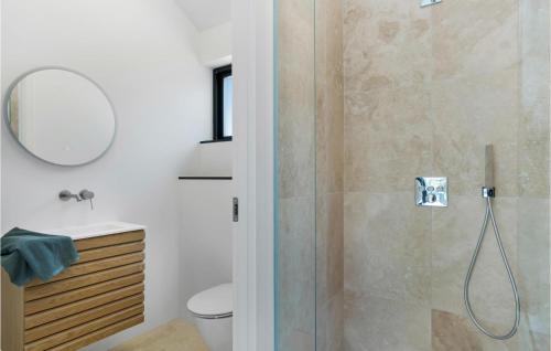 a bathroom with a shower and a toilet and a sink at Lovely Home In Græsted With Sauna in Græsted