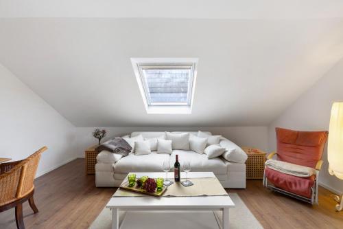 a living room with a white couch and a table at Ferienwohnung Obrighoven in Wesel