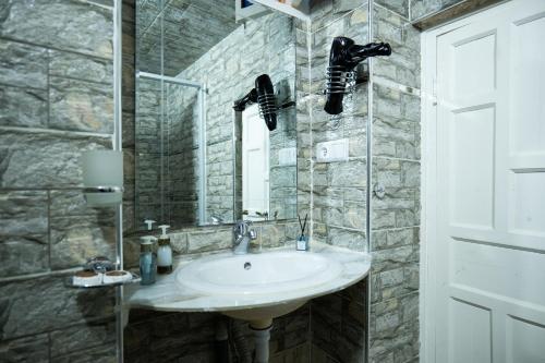 a bathroom with a sink and a mirror at RIAD AMR in Tangier