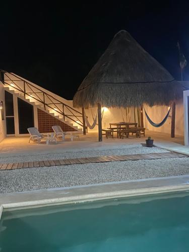 a resort with a swimming pool at night at Casa Loto B in Chelem