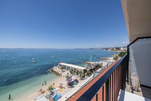 a view of a beach and the ocean from a balcony at Hotel Aria in Podstrana
