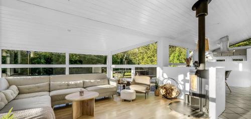 a living room with a couch and a table at Fjordferie Hemmet Strand in Hemmet