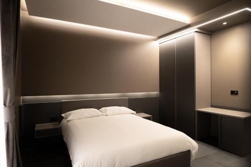 a bedroom with a white bed in a room at G-Rooms in Foggia