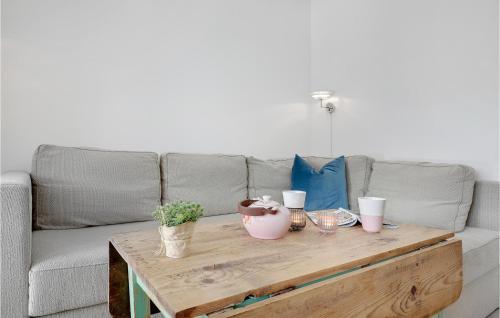 a living room with a couch and a wooden coffee table at Beautiful Apartment In Nexø in Neksø