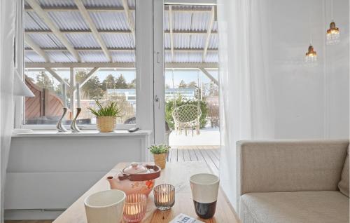a living room with a table and a couch at Beautiful Apartment In Nexø in Neksø