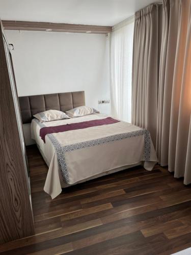 a bedroom with a bed and a large window at Garra Hotel in Konya