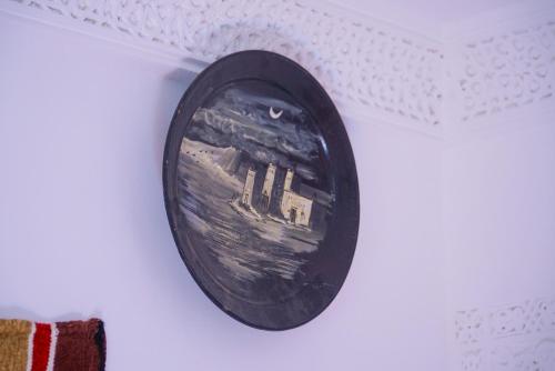 a picture of a building on a wall at RIAD AMR in Tangier
