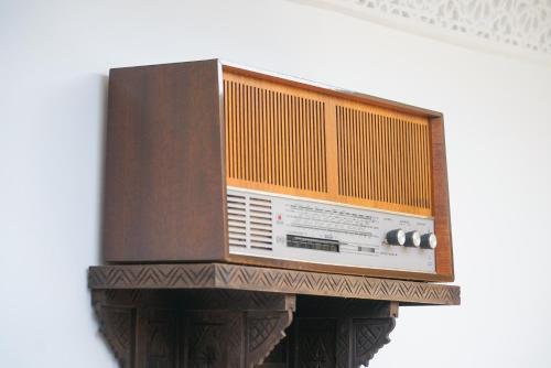 an old radio is hanging on a wall at RIAD AMR in Tangier
