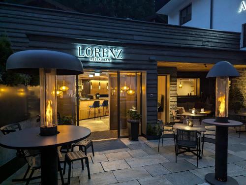 a restaurant with tables and chairs in front of it at ARLhome - Zuhause am Arlberg in Sankt Anton am Arlberg