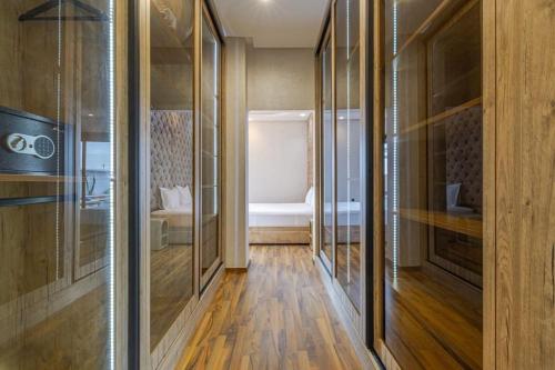 a hallway with wooden floors and glass walls at Villa de plain-pied avec piscine chauffée à Marrakech in Marrakech