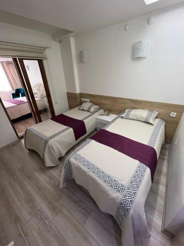 a room with two beds in a room with at Garra Hotel in Konya