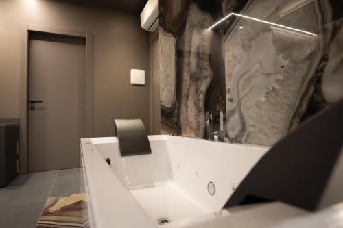 a bathroom with a white sink and a mirror at G-Rooms in Foggia