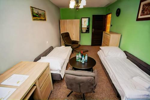 a room with two beds and a table in it at Apartament 3 SYPIALNIE, 3 BEDROOMS - Klimatyzacja - in Wrocław