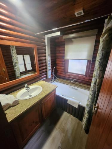 a bathroom with a sink and a window at Plettenberg, a Forever Resort in Plettenberg Bay