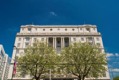 a white building with two trees in front of it at Adelphi Hotel in Liverpool