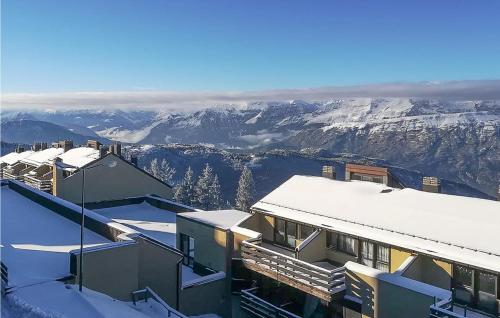 a building with snow covered roofs with mountains in the background at Stunning Apartment In Vason in Vason