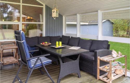 a patio with a couch and a table and chairs at Awesome Home In Rødby With Kitchen in Rødby