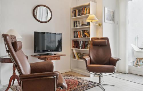a living room with two chairs and a television at One-Bedroom Apartment In Stege in Stege