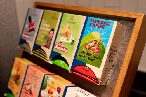 a row of books on a shelf at Stadtoase Kolping Hotel in Linz