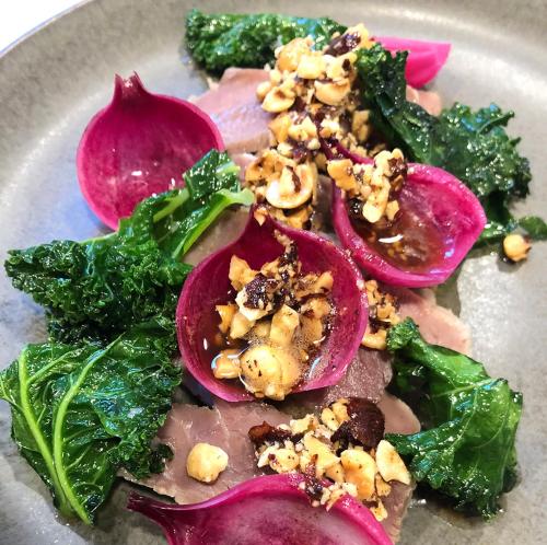 a plate of food with purple onions and greens at Idrættens Hus Hotel og Konference in Brøndbyvester