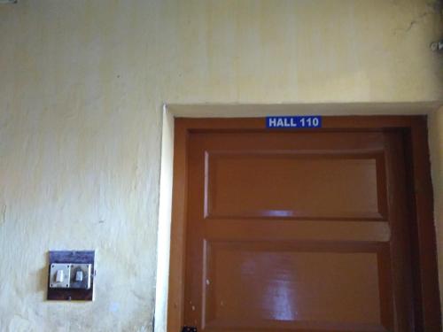 a door with a sign on top of it at Hotel Ganesh Lodge in Kanyakumari