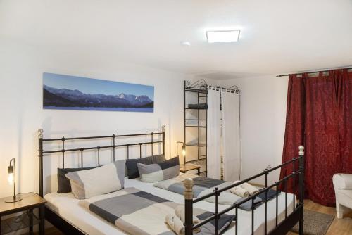 a bedroom with a bed and a couch at Alpen Lodge in Garmisch-Partenkirchen