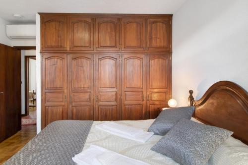 a bedroom with a wooden door and a bed at Casa do Adro do Soajo in Soajo
