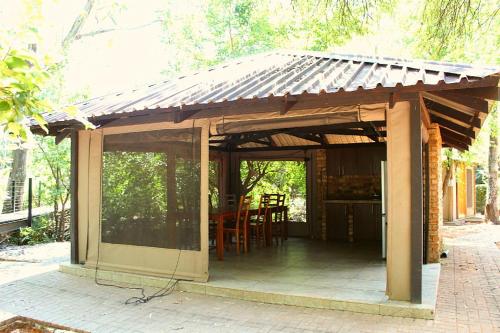 a pavilion with a roof on a patio at Casa Cara Resort in Parys