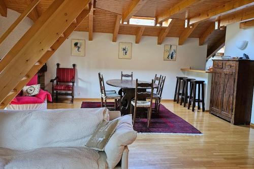 a living room with a couch and a table and chairs at Charming Chalet Downtown in Lens