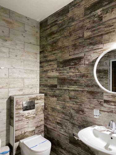 a bathroom with a toilet and a sink at Fontush Boutique Hotel in Ivano-Frankivsʼk