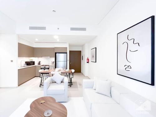 a living room with a white couch and a table at Luxury & Elegance in Downtown Fountain Views in Dubai