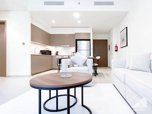 a living room with a table and a couch at Luxury & Elegance in Downtown Fountain Views in Dubai