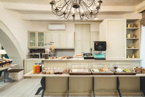 a kitchen with a counter with food on it at Elia Palazzo Hotel in Chania Town