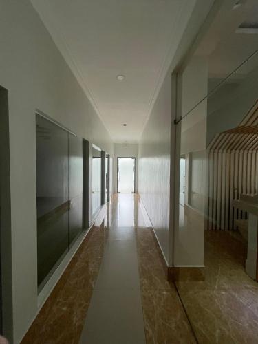 an empty hallway with glass walls and a staircase at B Hotels Angeles City in Angeles