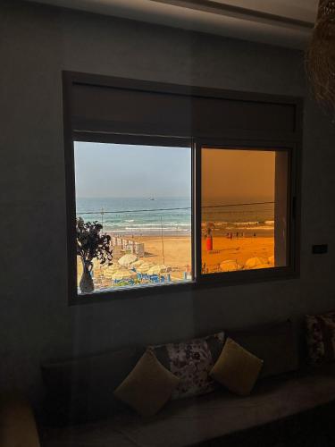 a window in a room with a view of the beach at Amouage Anza - Sea View Apartments in Agadir