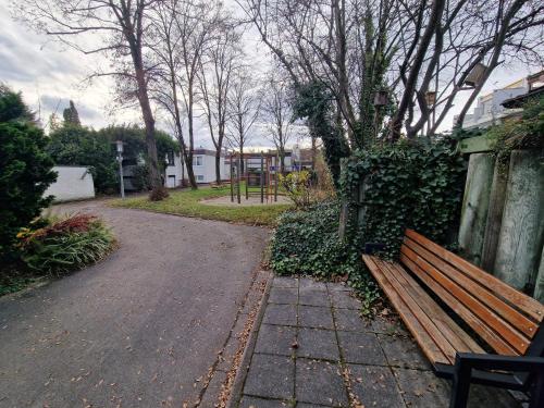 a wooden bench sitting next to a fence at Private Room Terrace in Kirchheim