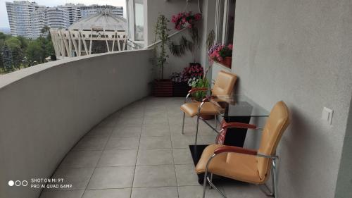 a balcony with chairs and a table on a balcony at Top Point Chisinau Apartment in Chişinău