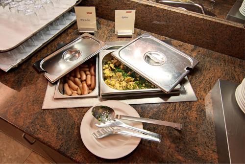 a table with two trays of food and a plate at BSW Schwarzwaldhotel Baiersbronn in Baiersbronn