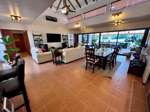 a living room with a table and chairs at Villa Solara 6 - Luxury 6 Bedroom Villa with Pool, Golf & Lake View in Río Hato