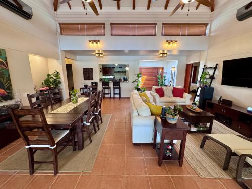 a living room with a couch and a table at Villa Solara 6 - Luxury 6 Bedroom Villa with Pool, Golf & Lake View in Río Hato