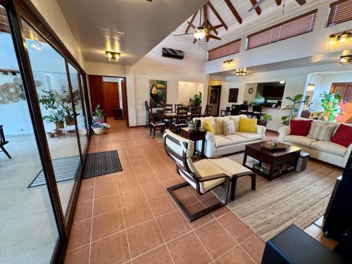 a large living room with couches and a table at Villa Solara 6 - Luxury 6 Bedroom Villa with Pool, Golf & Lake View in Río Hato