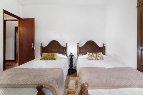 two beds sitting next to each other in a room at Casa do Adro do Soajo in Soajo
