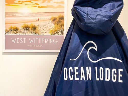 a blue trash bag with the words west writing ocean lodge at Cosy Coastal Getaway in West Wittering