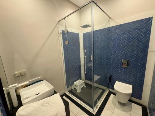 a bathroom with a glass shower and a toilet at Villa Ania in Marrakesh