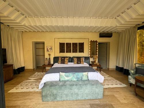 a bedroom with a large bed and a couch at Villa Ania in Marrakesh