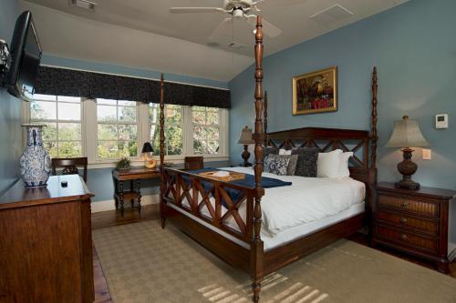 a bedroom with a canopy bed and a desk at 2 Bedroom Wilson Village Home 53 in Bluffton