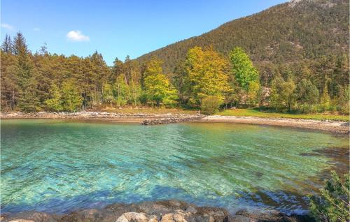 a large body of water with trees in the background at Cozy Home In Bjoa With Wifi in Utbjoa